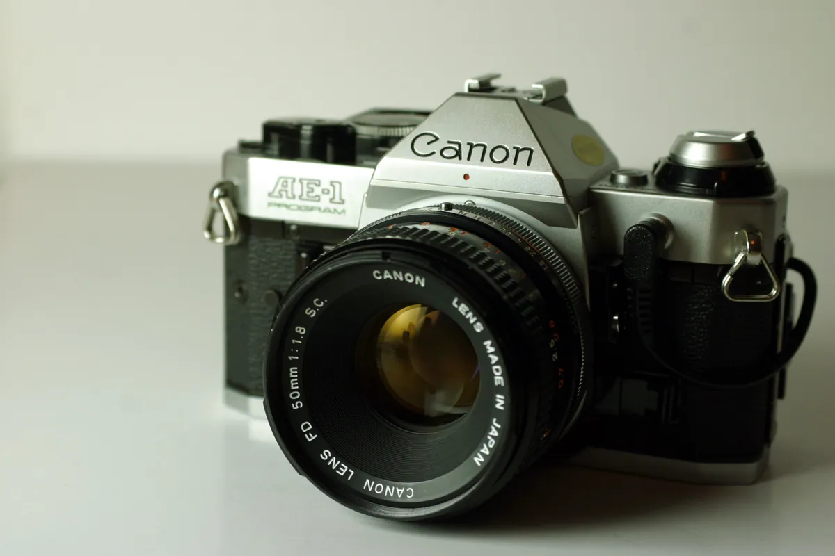 Canon AE-1 Program: a silver and black Canon AE-1 Program with a 50 mm lens