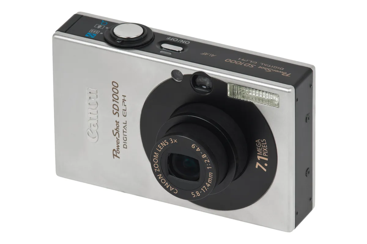 Canon PowerShot SD1000: a silver Canon PowerShot SD1000 digital camera, seen from the front