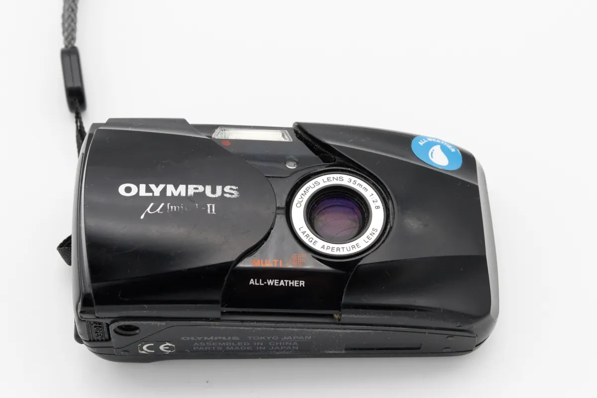 Olympus Mju II: a black Olympus Mju II with its sliding lens cover open